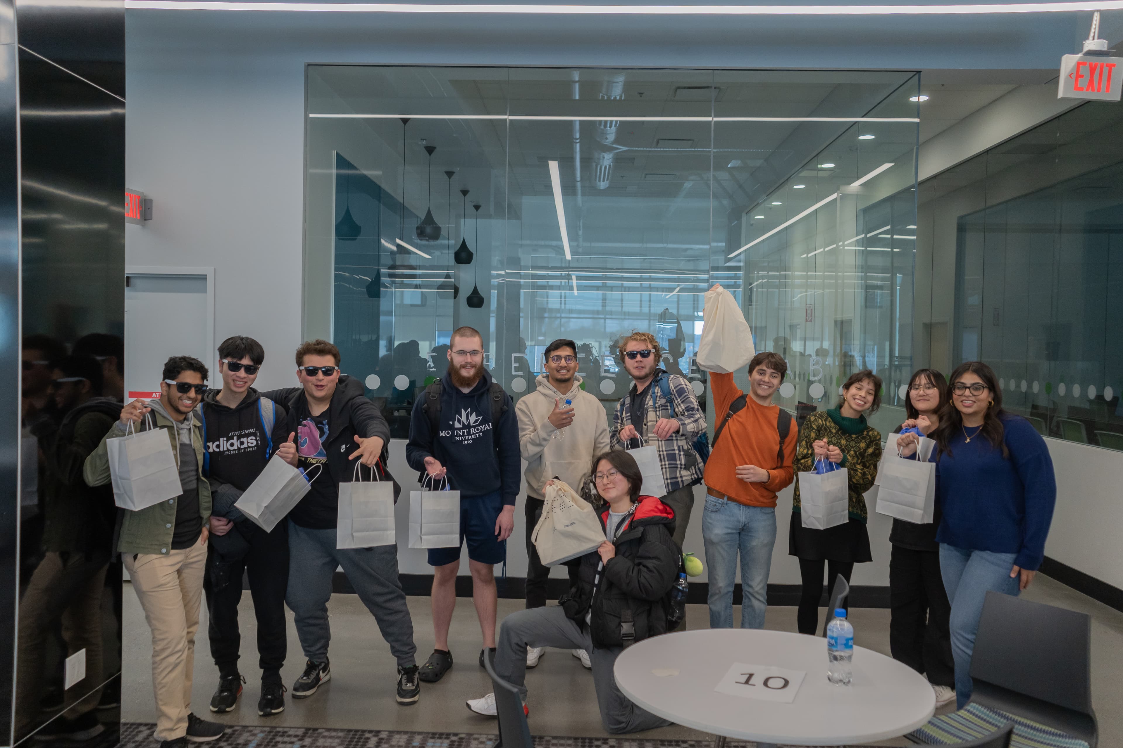 Some happy hackathon participants posing with their prizes.