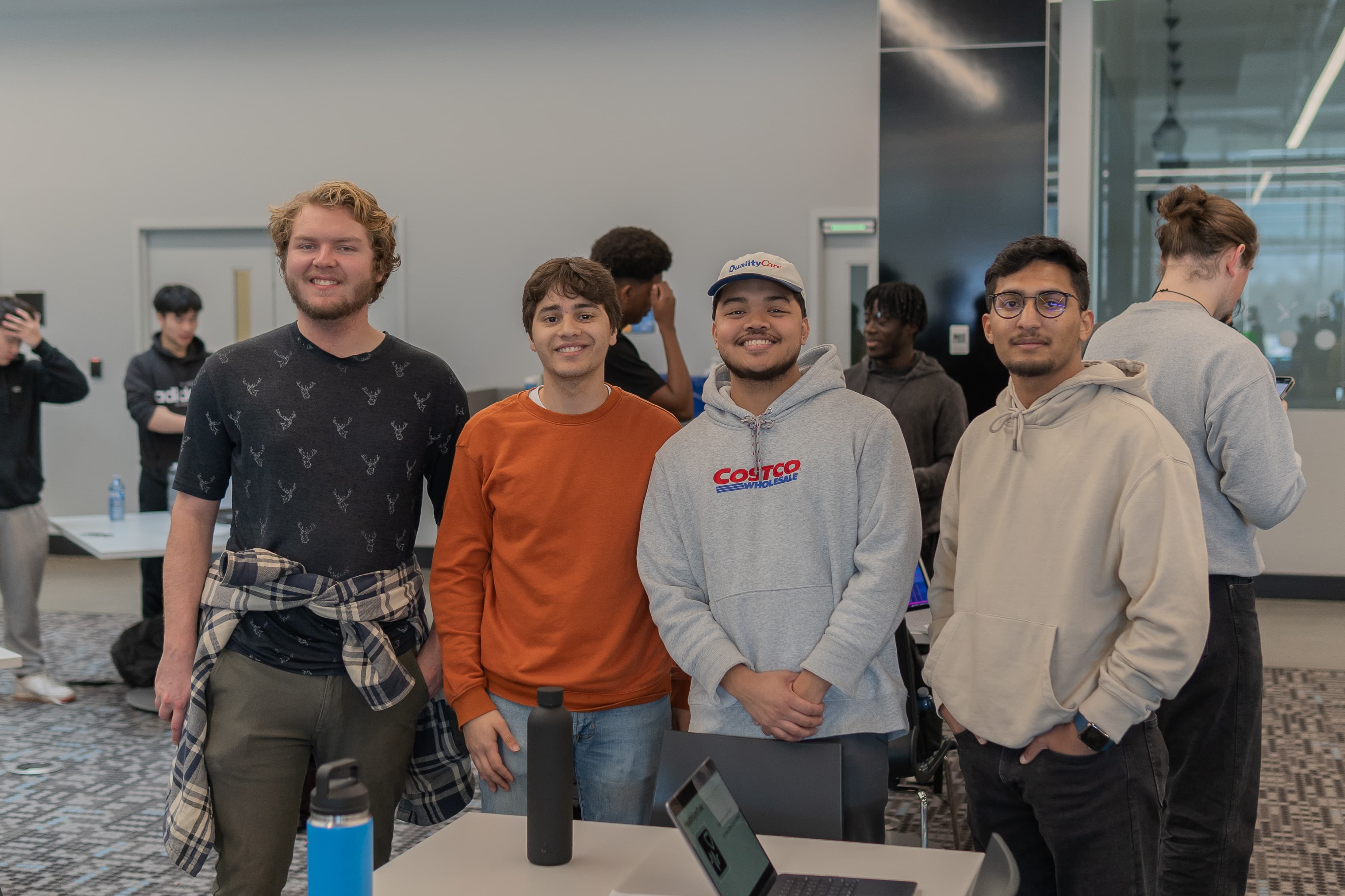 A proud team of hackathon participants posing with their project.