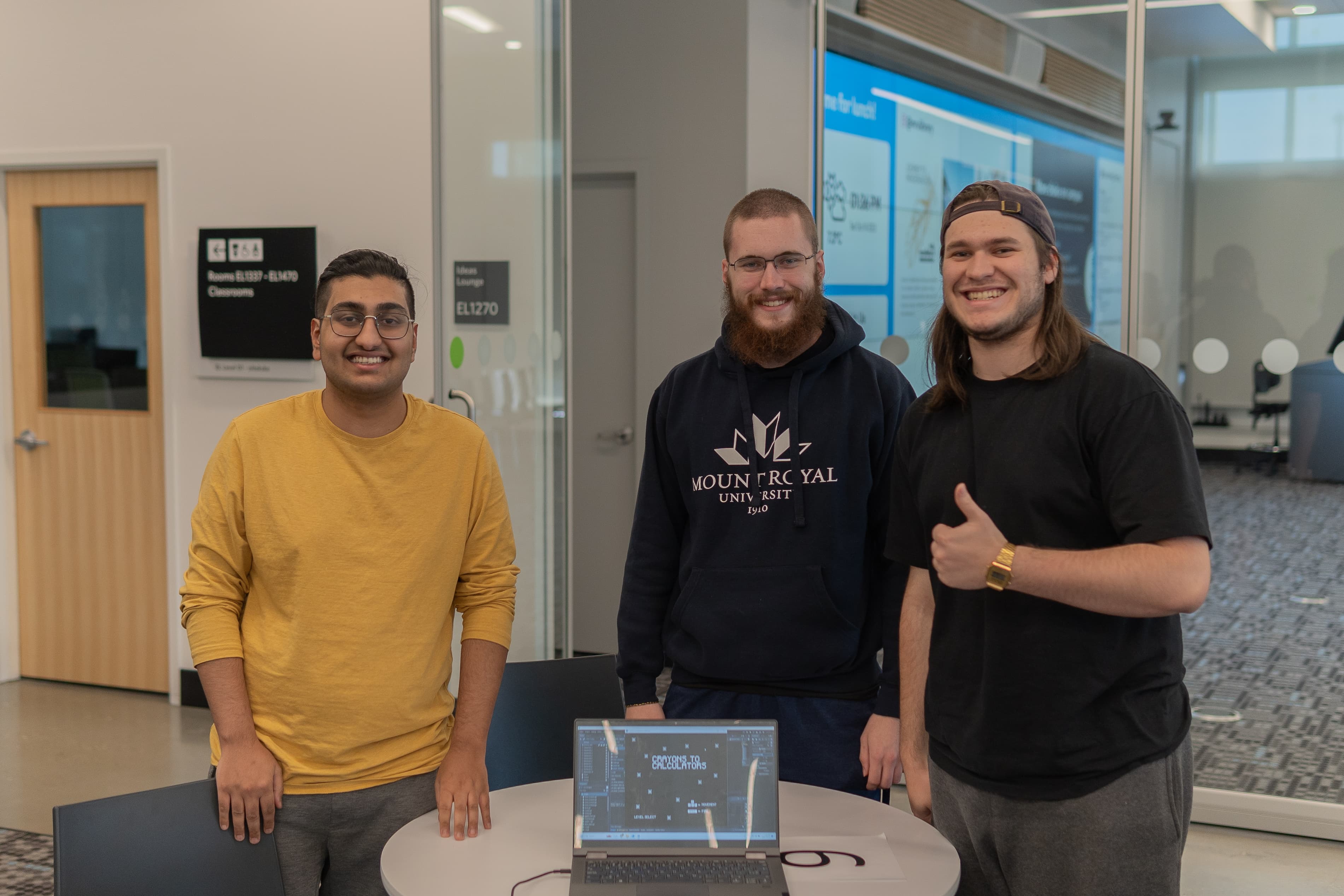 A group of hackathon participants posing with their project.